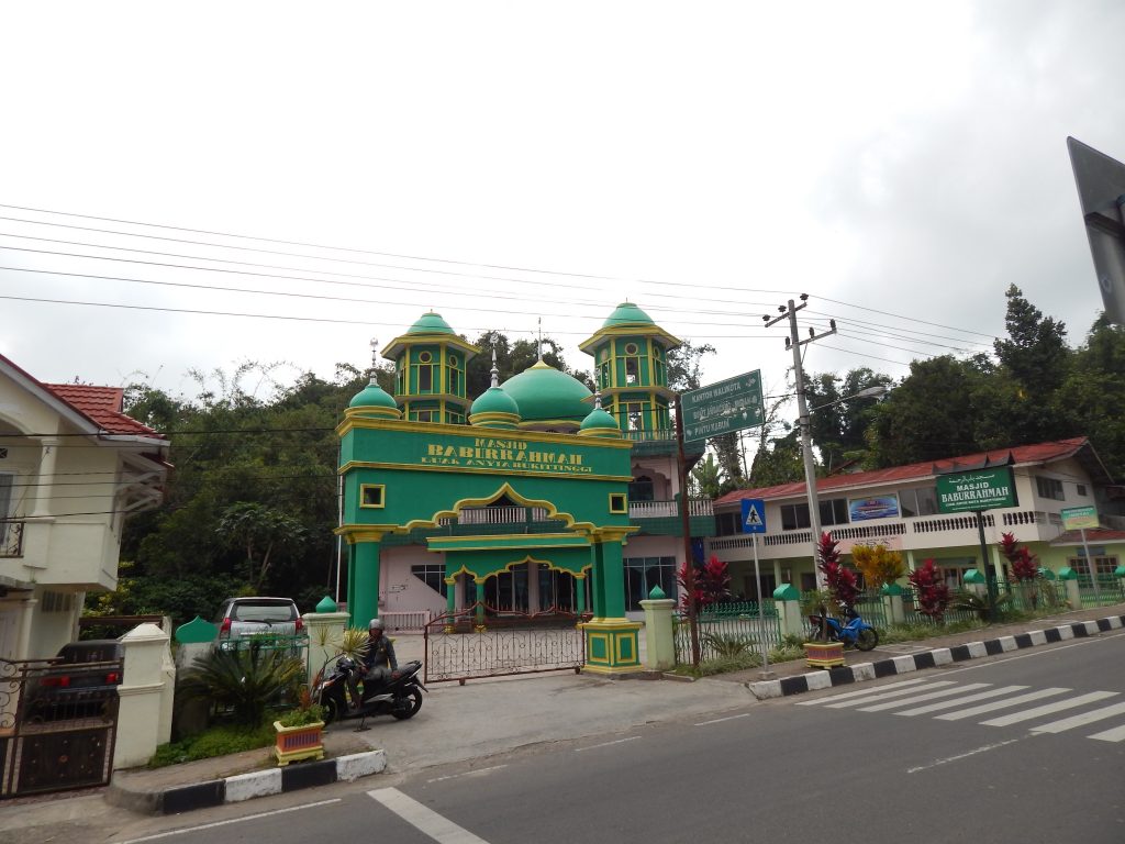 Green colored mosque in center of Bukittinggi