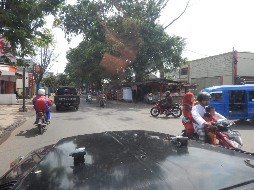 Children with parents on moped in Malang, Indonesia