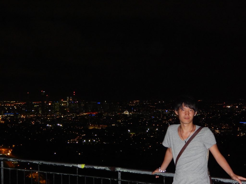 Toshi in front of the view of Brisbane